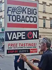 The e-cigarette retailer marketing sign states, "F#@K Big Tobacco, vape on, and free tastings".
