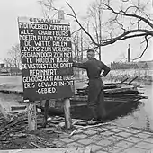 Warning sign for minefield in inundated area.
