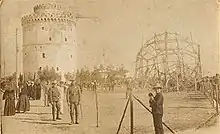 B&W photo of wreckage next to w round castle