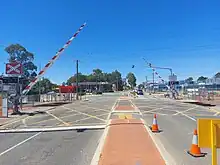 Level crossing with the boom gates partially lowered in a diagonal position