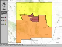 A map of a boxy state (New Mexico) with three colors on it-- the color covering the top third of the box is the third district.