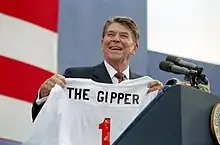 Photograph of President Ronald Reagan holding a jersey with the name "The Gipper", at a 1984 campaign rally in New York